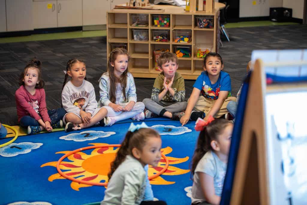 Timberline Preschool students sit in a circle in class